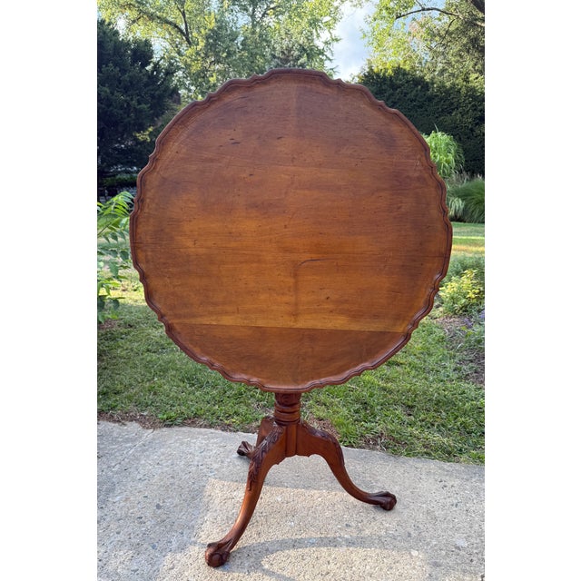 Traditional piecrust edge tilt top table with birdcage construction, turned tripod base terminating in splayed ball and...