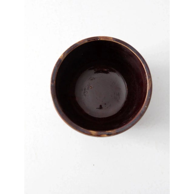 An antique turn-of-the-century stoneware brownware bowl featuring a distinctive ridged lip and a classic utilitarian form....