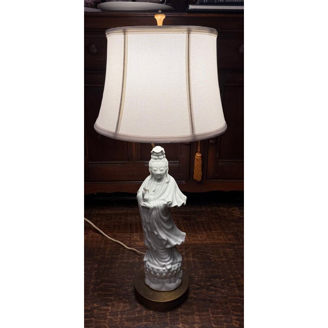 Elegant vintage white porcelain Guanyin figural table lamp in the Blanc de Chine tradition, mounted on an ornate pierced...