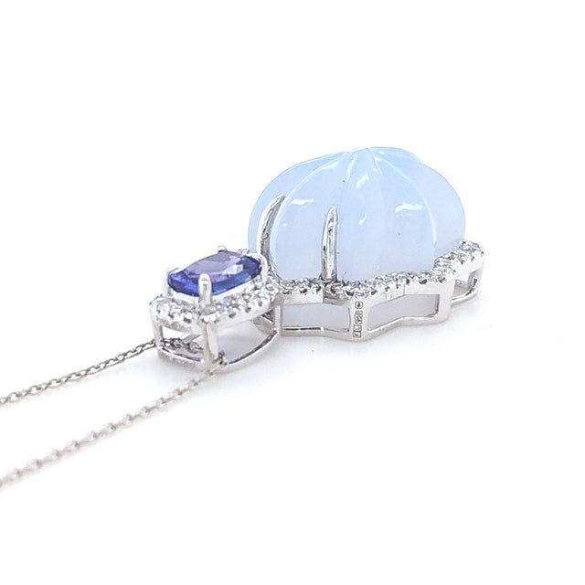 A sculptural platinum pendant featuring a 12.26ct chalcedony paired with a vivid tanzanite accent. The chalcedony’s soft,...