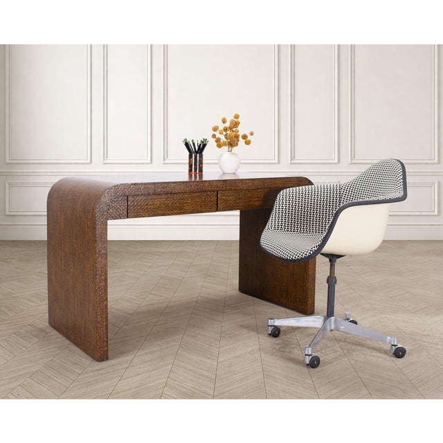 A stylish mid-century modern pair of swivel office task chairs designed by Charles and Ray Eames for Herman Miller. The...