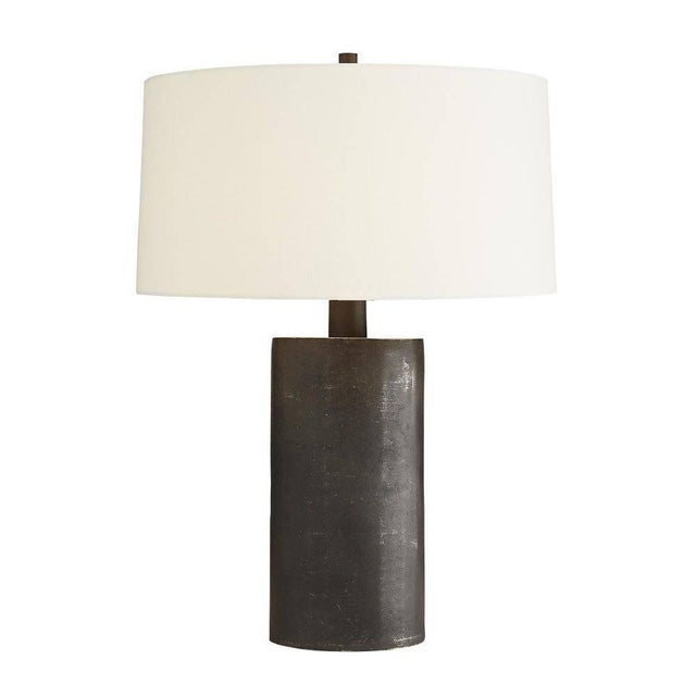 Dark and mysterious, this table lamp brings light even with its own inky hue. It’s completely crafted from blackened...