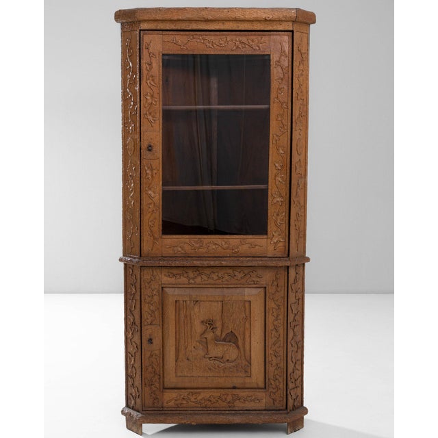 Carved oak vitrine cabinet in Warm Honey Oak. Finished in warm honey oak, this carved oak vitrine cabinet is distinguished...