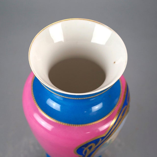 An antique French Old Paris portrait vase offers footed porcelain construction with reserve having hand painted genre...