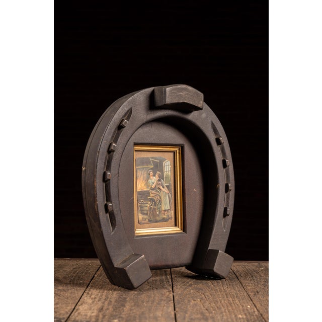 Folk art wall hanging constructed in the form of an oversized horseshoe, carved and painted to imitate the appearance of...