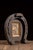 Folk art wall hanging constructed in the form of an oversized horseshoe, carved and painted to imitate the appearance of...