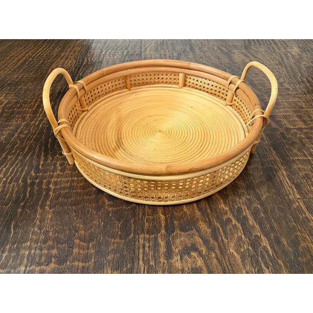 Beautiful oversized vintage round rattan tray featuring a tightly coiled base, open woven cane sides, substantial rounded...