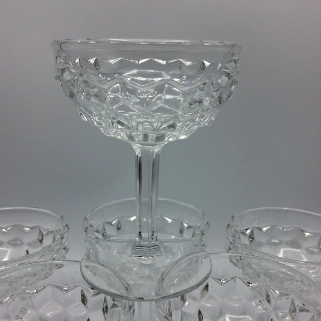 Beautiful set of 7 Champagne or tall sherbet pressed glass glasses. Made by Fostoria in the USA. Pattern American.
