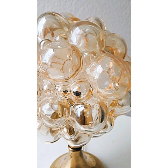 Helena Tynell Object: "BUBBL" table lamp 1-bulb E14 Age: circa 1960s Color/Material: Amber/Metal/Brass/Glass Dimensions:...