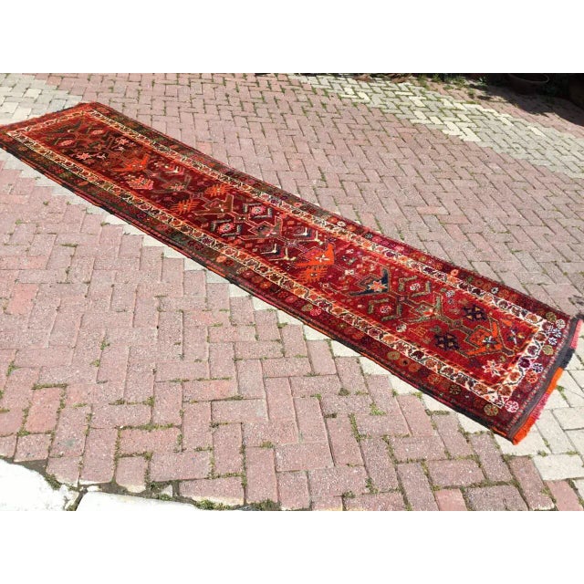 This gorgeous hand knotted vintage Anatolian runner rug is approximately 70 years old in excellent vintage condition. The...