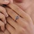This contemporary bypass ring features 1.03 ct of a striking pear-shaped blue sapphire, set in 14k yellow gold. The pear-...
