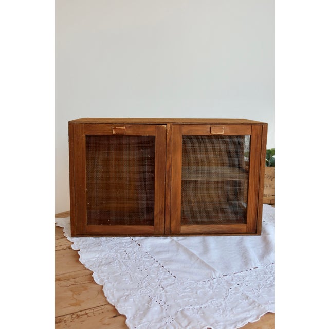 Antique wooden pantry with two metal mesh doors, ideal for storing fruit, cheese, or bread while allowing air to...