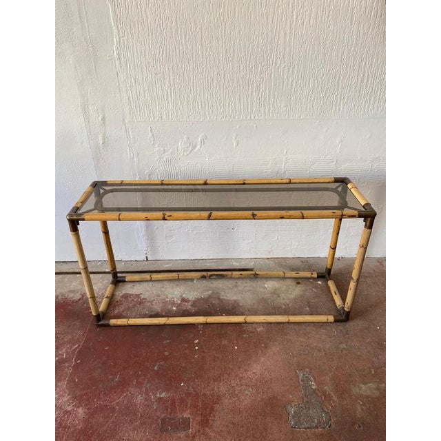 An elegant Italian Mid-Century Modern large bamboo and smoked glass console or sofa table by Giovanni Banci circa 1970....