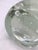 A decorative blown glass sculpture depicting a stylized bird, characterized by soft, clean lines. The body features a...