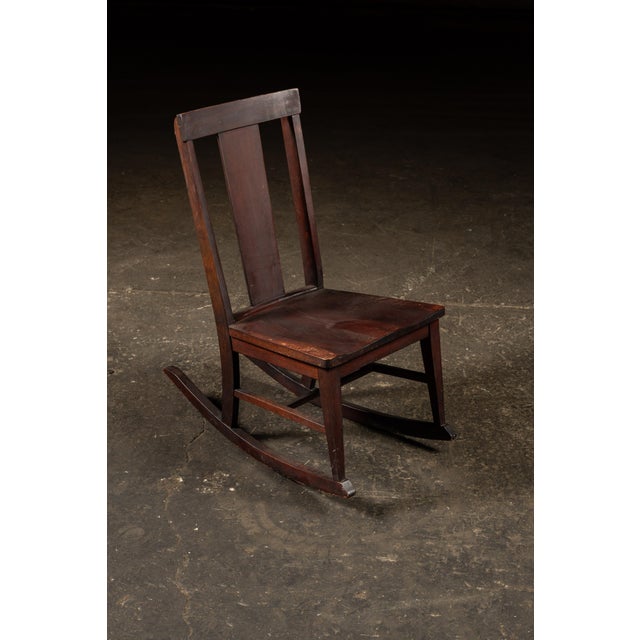 Antique mahogany rocker. This rocker dates to the early 20th century and reflects the pared-down sensibility of the...