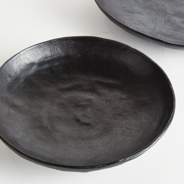 This pair of handcrafted bowls has simple round silhouettes, with a matte finish and subtle texture. They can be styled...
