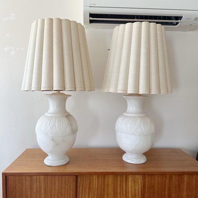 Large Italian solid alabaster table lamps with incised leaf relief from the 1970s. The lamps are heavy solid alabaster. In...