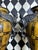 Pair of grand 32" vintage Neoclassical-style figural table lamps with sculptural metal urn-form bodies. Each lamp is...