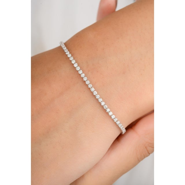 Enhance your elegance with this sleek round diamond tennis bracelet. Crafted with precision, each brilliant diamond is set...