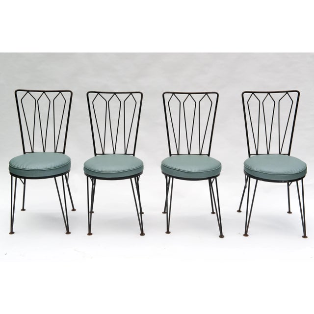 This set of Mid-Century Modern wrought iron dining chairs has the look and high quality construction of Salterini but are...