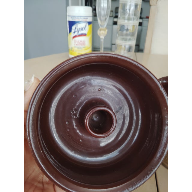 These mid-century Italian pottery candle holders are in vintage condition. Both of the vessels have a small chip to the...