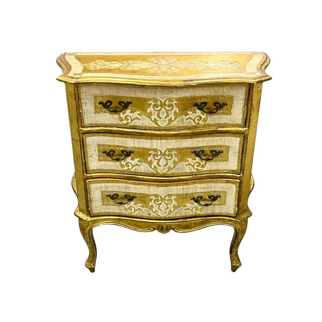 A charming mid-century Italian commode in the manner of Florentia, featuring beautifully hand-painted scrolling details...