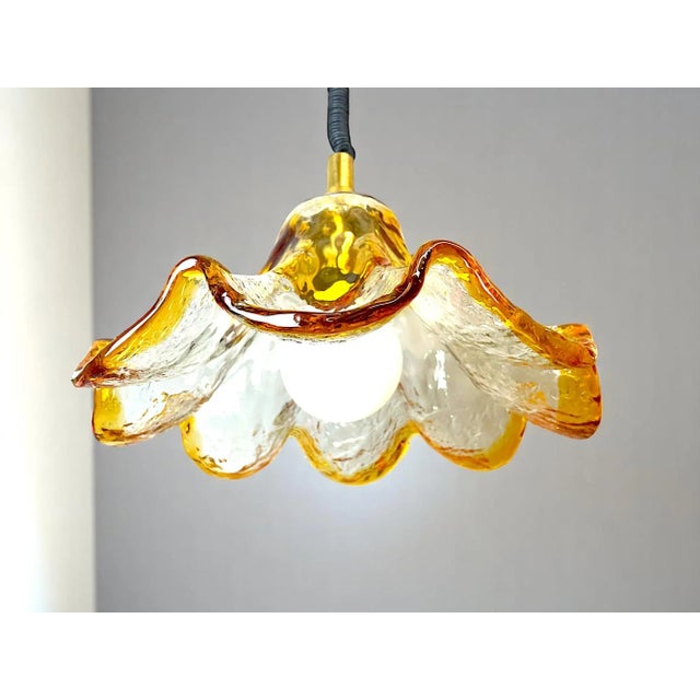 Murano Glass Hanging Lamp Made of Tulip-shaped hand-blown Murano glass in amber and clear tones, and equipped with a...