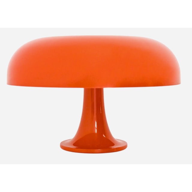 An iconic pair of 1970's table lamps in the "Nesso" design by Giancarlo Mattioli for Artemide. The bright orange Nesso's...