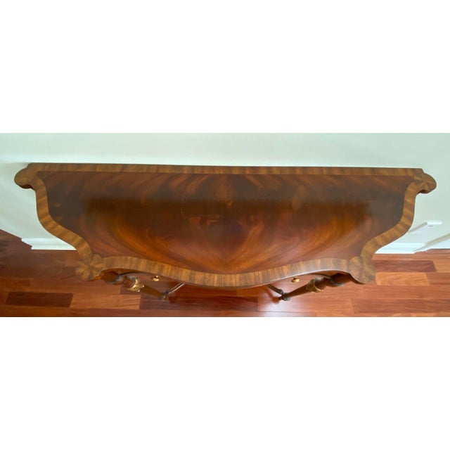 Maitland Smith crotch mahogany late Georgian console table, antique gold metal leaf accents.