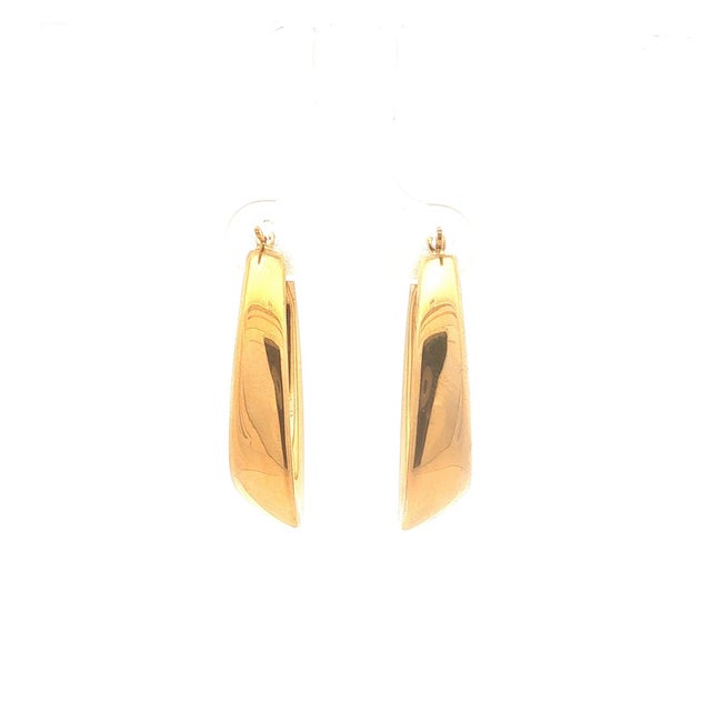 A pair of 14k gold hoop earrings. These have a sleek, elongated design. In good condition.
