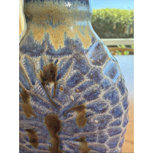 Offered here is a beautifully textured signed studio pottery flask measuring 7 1/2 inches tall, including its original...