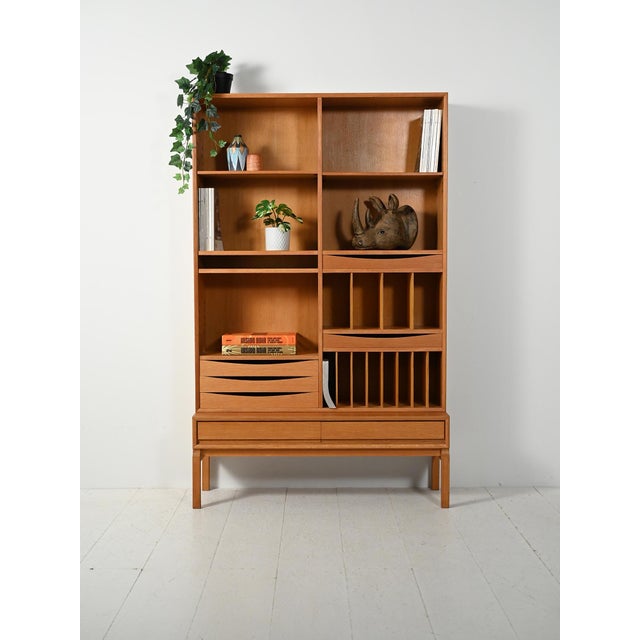 Scandinavian oak bookcase from the 1960s, featuring a modular and rational design, with a freestanding base featuring...