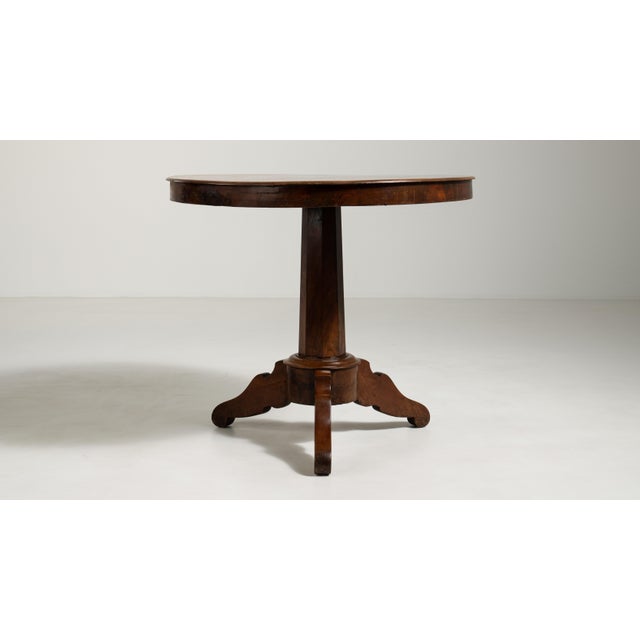 A compact round side table combining simple structure with decorative character. The round top softens its presence within...
