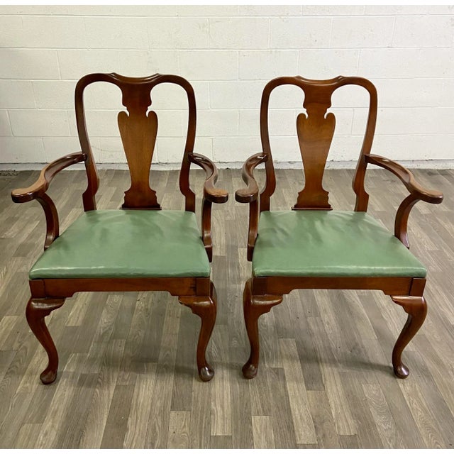 This is a stunning pair of vintage Queen Anne style dining chairs with green vinyl seats. They feature beautiful cabriole...