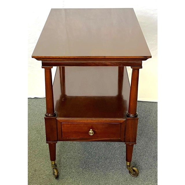 Timeless traditional style side table. It's very well made of solid wood with tapered legs on four sturdy brass casters....