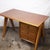 A teak and formica desk from the 1960s. The desk features chunky v taperd shaped legs. This piece is attributed to the...