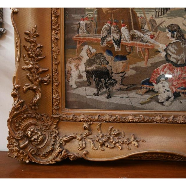 Large Flemish decorative tapestry panel depicting a medieval hunting scene with figures, horses and dogs set within an...