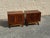 Pair of vintage Mid-Century Modern nightstands featuring sculptural geometric carved door panels, warm wood finishes, and...