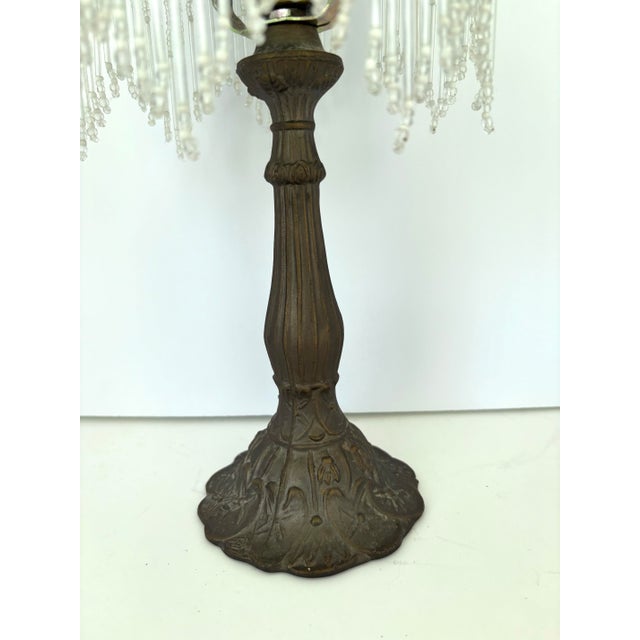This charming vintage boudoir lamp features an ornate cast metal base with flowing Art Nouveau–inspired floral detailing,...