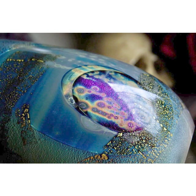 Striking studio art glass vase by Robert Eickholt from his 1982 “Cosmic Blue” series. This piece features luminous...