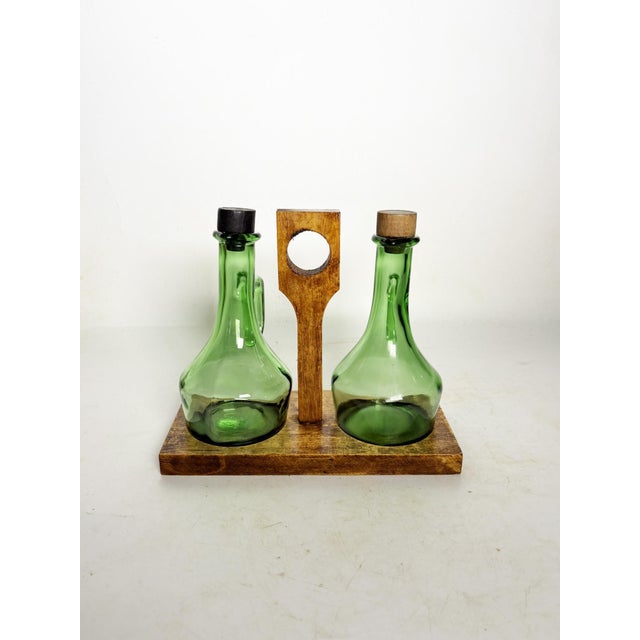 Olive wood and glass oil and vinegar set, France, 1950s, with rustic and authentic charm. This piece consists of two...