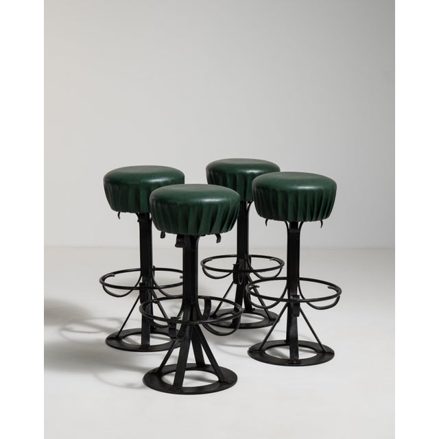 Rooted in the refined sensibility of 1970s French design, this distinguished set of four bar stools unites robust wrought...