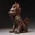 A striking Chinese bronze figure of a Qilin, a mythical hooved creature. The statue is seated on its haunches and features...