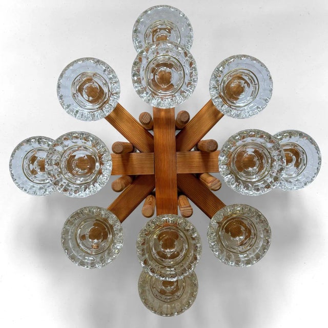 A magnificent, large modernist table centerpiece in the form of a pinewood candelabra, featuring twelve glass...