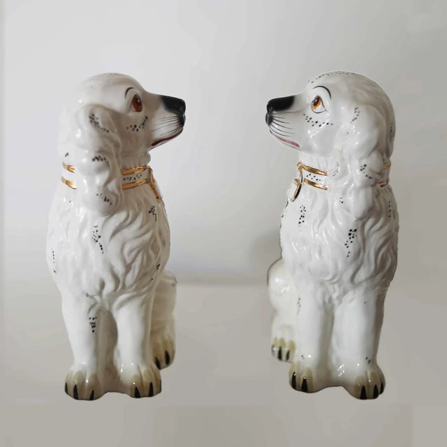 Pair of antique, early 20th century earthenware Staffordshire spaniels.