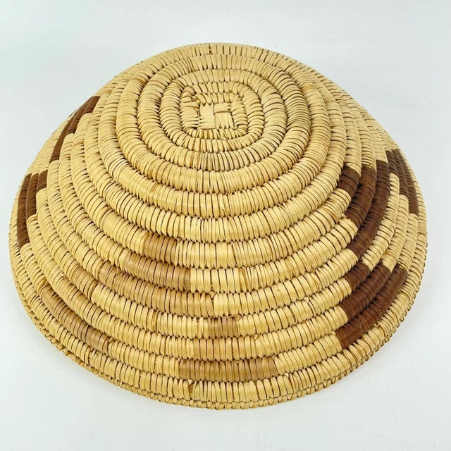 Handwoven basket made by the Tonga people of Zambia. This basket has a snake belly edge trim.Traditionally crafted from...
