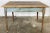 Antique primitive farmhouse table featuring weathered paint to base. Two tones of blue to aprons. Wonderful patina. Leg...