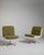 A pair of mid-century Space Age swivel chairs characterized by rounded forms and functional bases. These chairs reflect...