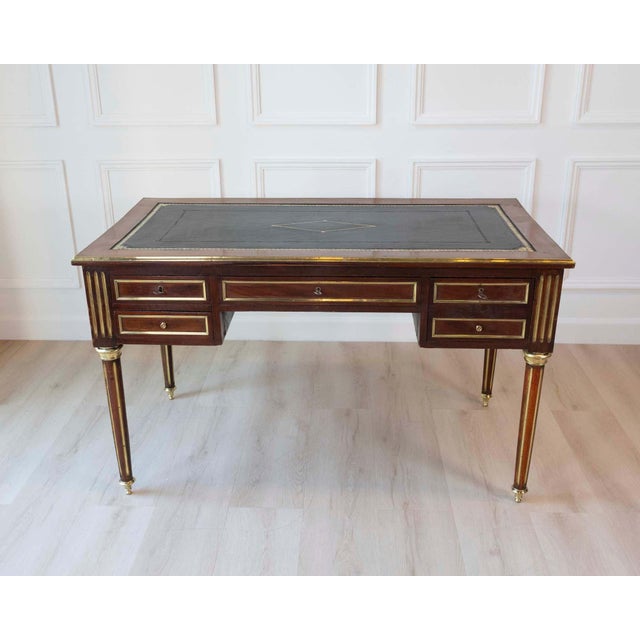 Elegant Louis XVI-style double-sided flat desk crafted in figured wood and accented throughout with refined brass details....