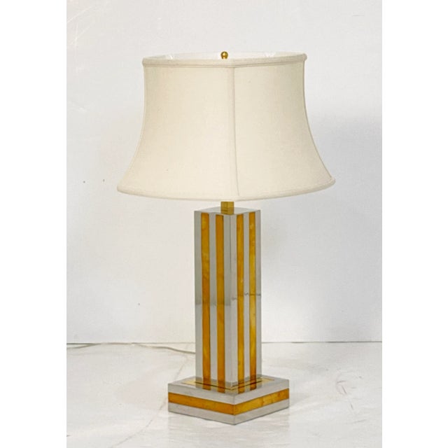 A fine Italian Modern table lamp of chrome and brass by the celebrated designer, Romeo Rega, featuring an elegant column...